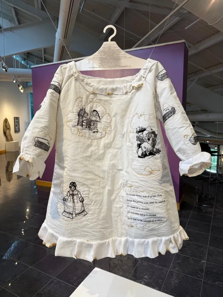 A piece of clothing made of cloth with graphic stitching art layered into it.